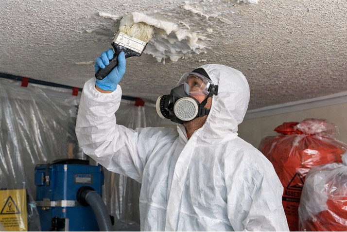 artex removal specialist applying gel to ceiling, removing an artex ceiling safely with wet method, artex ceiling removal waste packaging procedure, artex removal